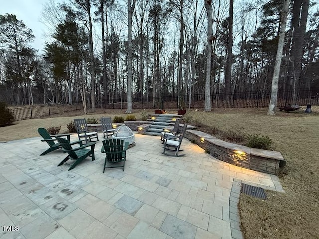 view of patio with a fenced backyard and a fire pit