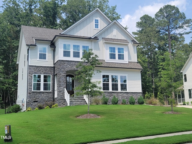 664 The Parks Dr, Pittsboro, NC 27312 - craftsman-style house with stone siding, board and batten siding, a front lawn, and a shingled roof