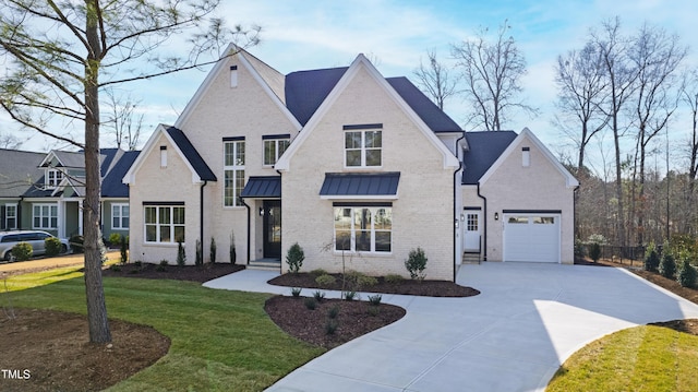 view of front of property with a garage, brick siding, concrete driveway, a standing seam roof, and a front yard