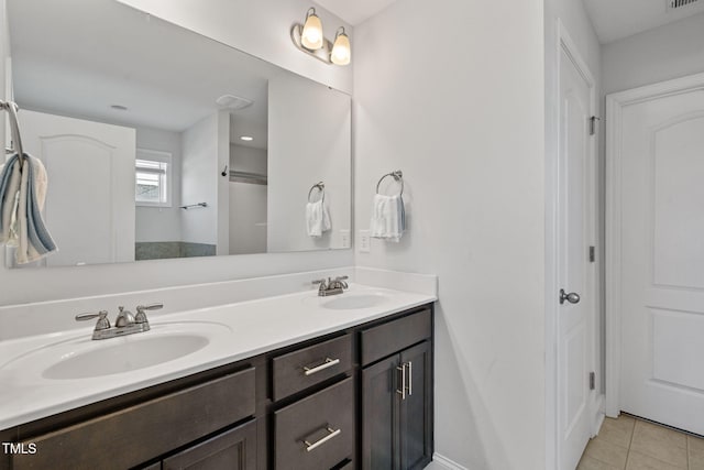 bathroom featuring tile patterned floors, visible vents, a sink, and double vanity