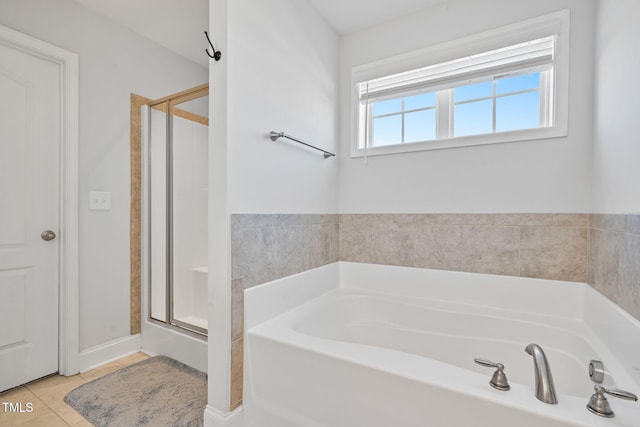 full bathroom with a bath, tile patterned floors, and a stall shower