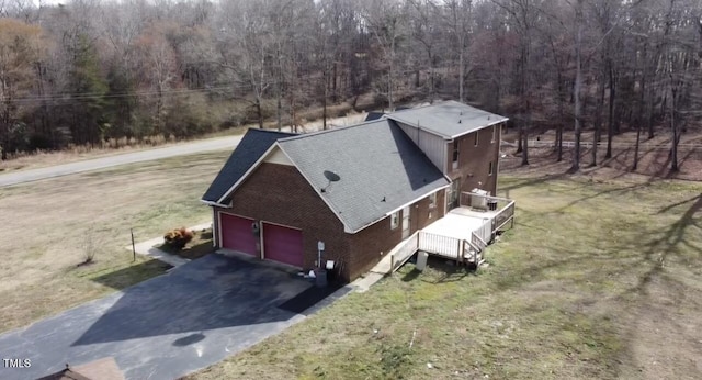 drone / aerial view with a wooded view