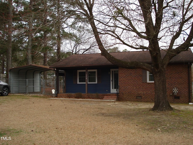 single story home featuring brick siding, a shingled roof, crawl space, a front lawn, and a detached carport