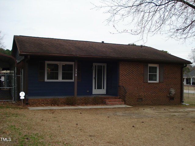 ranch-style house with a shingled roof, crawl space, and brick siding