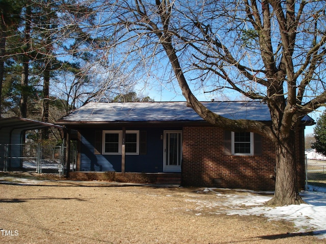 ranch-style house featuring crawl space, fence, a carport, and brick siding