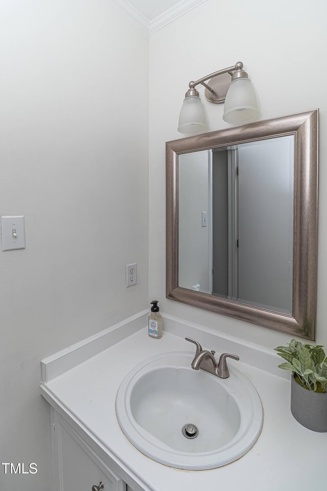 bathroom featuring crown molding and vanity