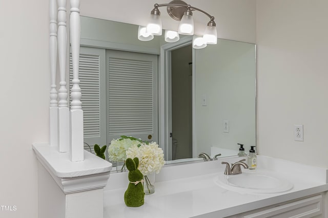 bathroom with a closet and vanity