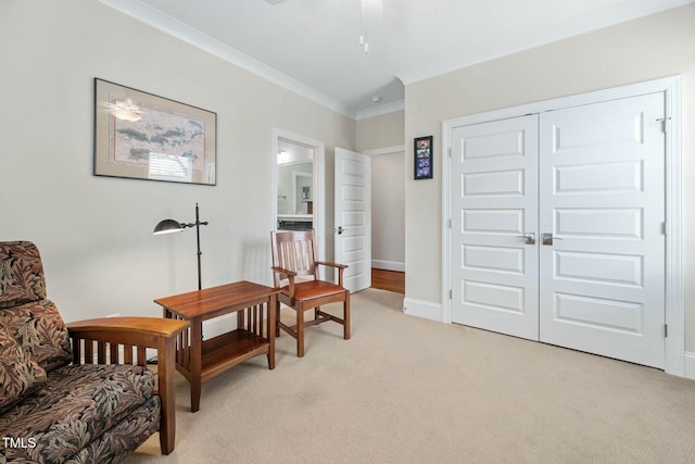 living area with light carpet, ornamental molding, and baseboards