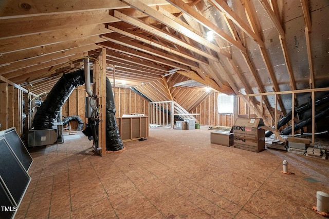 unfinished attic with an upstairs landing