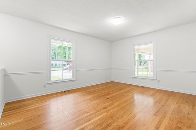 empty room featuring light wood-style floors and baseboards