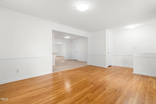 spare room with light wood-type flooring and baseboards