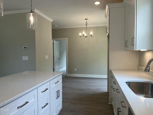 162 Kirkwall Ln, Selma, NC 27576 - kitchen featuring dark wood-style floors, a sink, baseboards, an inviting chandelier, and ornamental molding