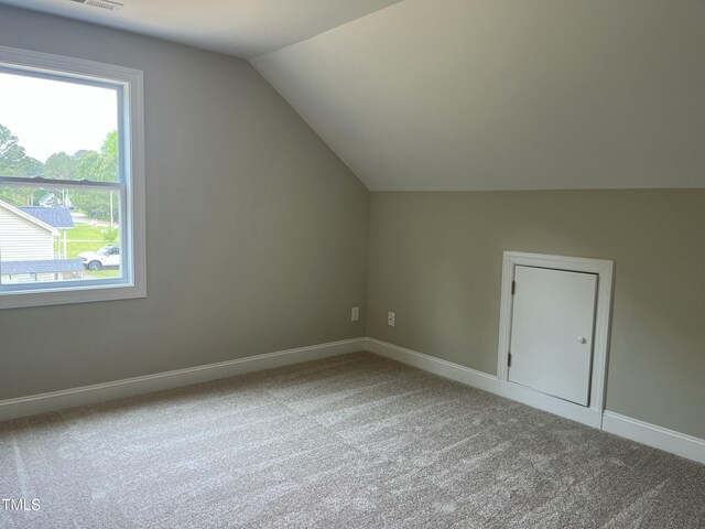 162 Kirkwall Ln, Selma, NC 27576 - bonus room featuring baseboards, vaulted ceiling, carpet floors, and plenty of natural light
