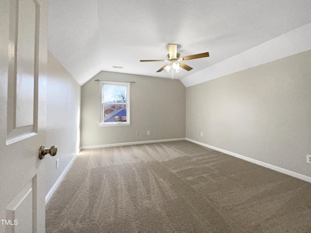 bonus room with carpet flooring, vaulted ceiling, and baseboards