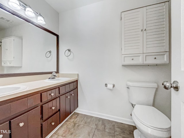 bathroom featuring visible vents, a sink, toilet, and double vanity