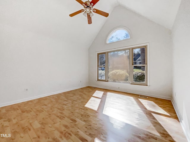 interior space featuring ceiling fan, high vaulted ceiling, light wood-type flooring, and baseboards