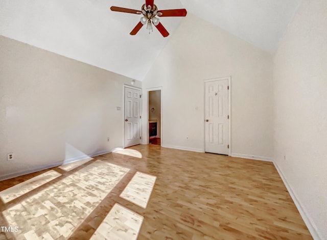 unfurnished bedroom with high vaulted ceiling, a ceiling fan, baseboards, and wood finished floors