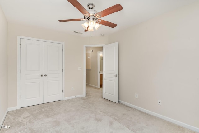 unfurnished bedroom with light colored carpet, visible vents, and baseboards