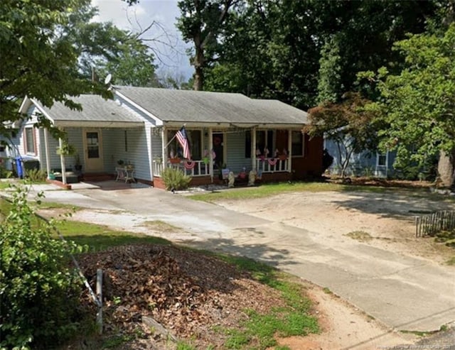 view of front of home featuring concrete driveway and covered porch