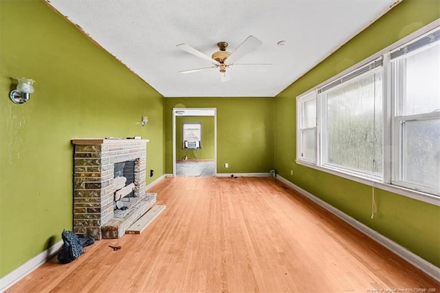 unfurnished living room with a wealth of natural light and baseboards