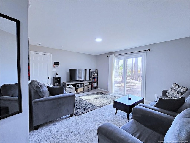 living area with baseboards and carpet