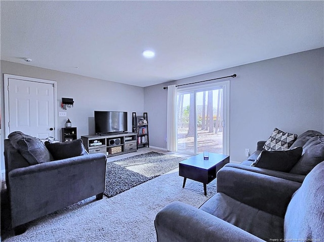 living room featuring carpet flooring and baseboards