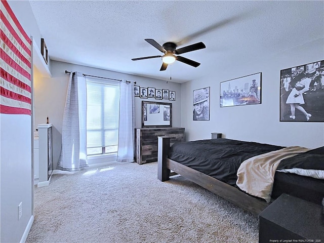 carpeted bedroom featuring baseboards, a ceiling fan, and a textured ceiling