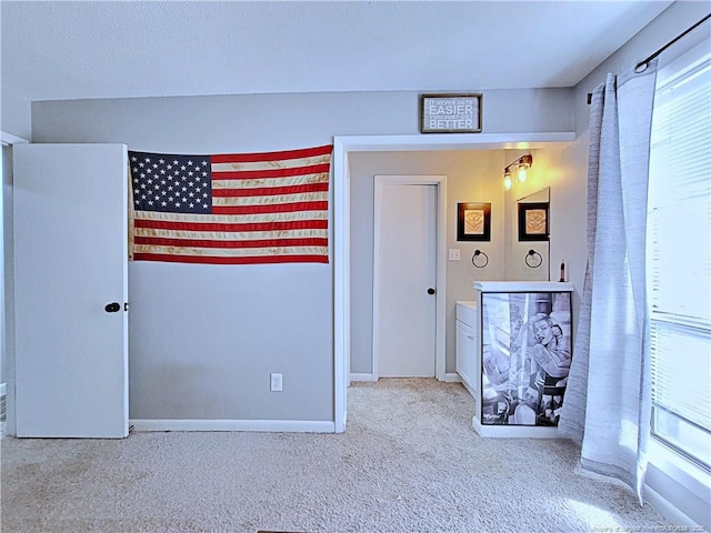 unfurnished bedroom featuring carpet flooring and baseboards