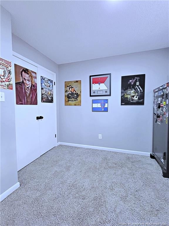 interior space with baseboards and carpet floors