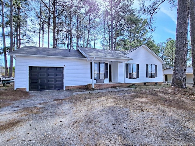 ranch-style house with driveway, crawl space, and a garage