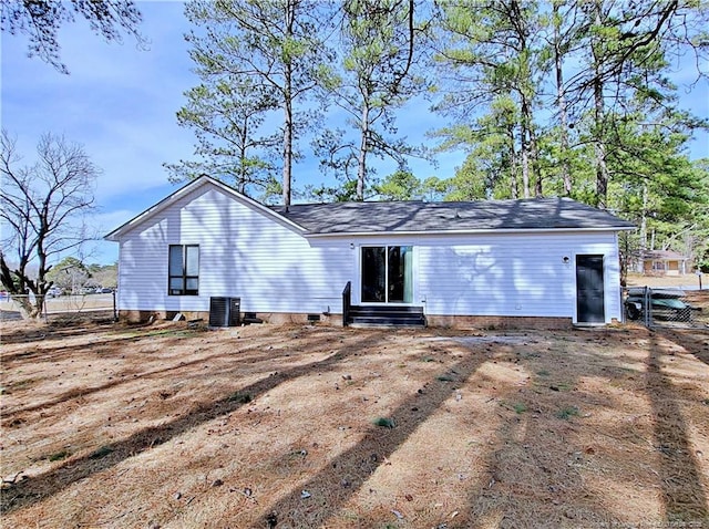 back of house with fence, central air condition unit, entry steps, and crawl space