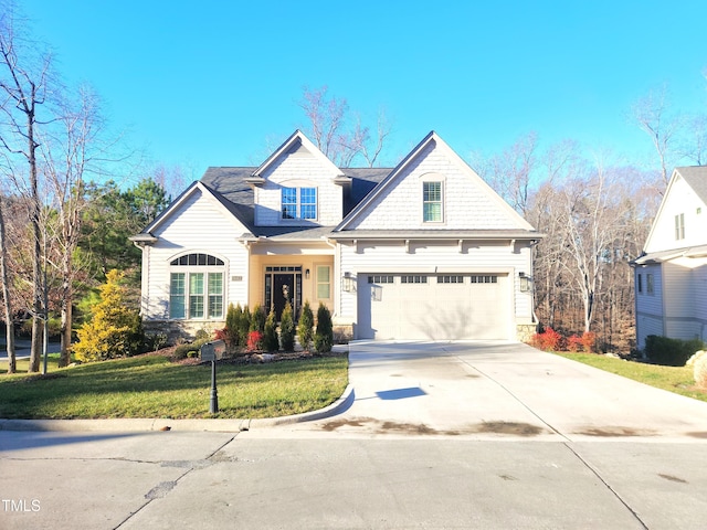 view of front of home with driveway, a front lawn, and an attached garage