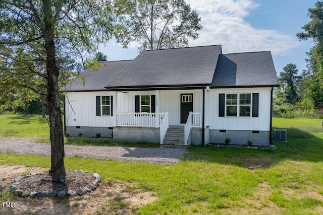 view of front of house with a shingled roof, a front yard, crawl space, and covered porch