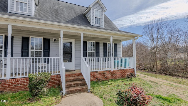 view of front of house featuring a porch and roof with shingles