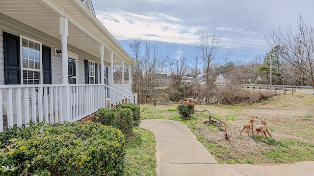 view of yard featuring covered porch