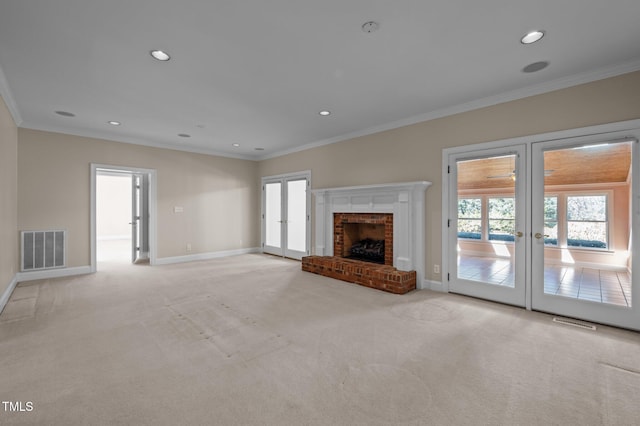 unfurnished living room featuring light carpet, baseboards, visible vents, ornamental molding, and french doors