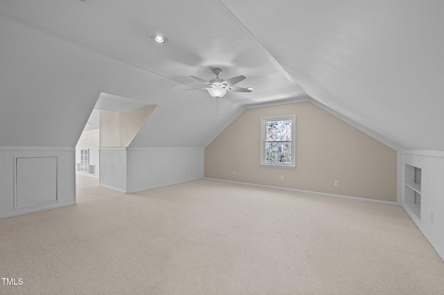 bonus room featuring light carpet, baseboards, a ceiling fan, and lofted ceiling