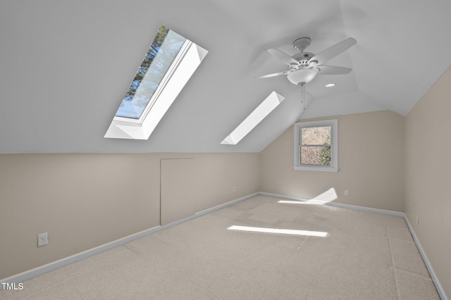 bonus room featuring lofted ceiling, ceiling fan, carpet, and baseboards