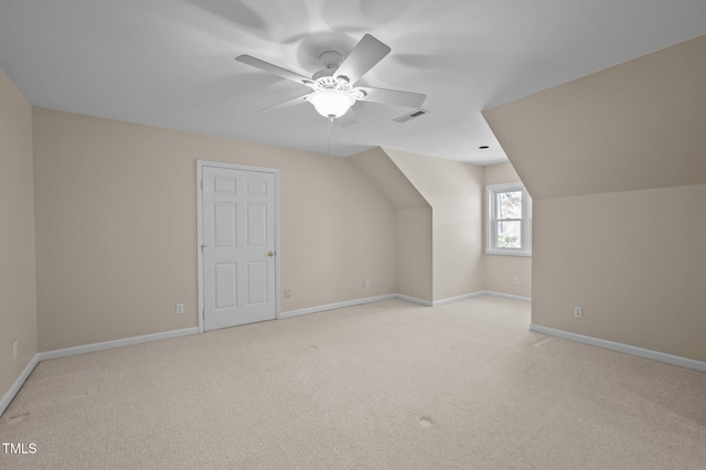 bonus room with light colored carpet, visible vents, and baseboards