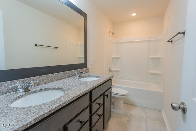 bathroom with toilet, tile patterned flooring, double vanity, and a sink