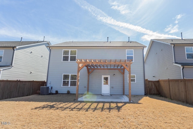 back of house featuring a lawn, a patio, a fenced backyard, central air condition unit, and a pergola