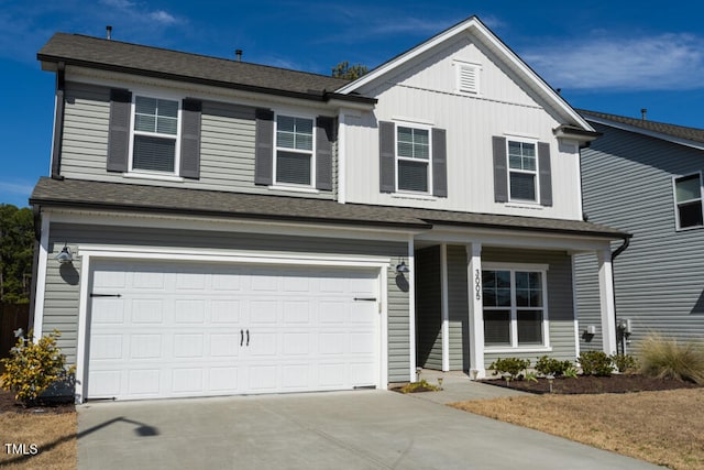 view of front of house featuring a garage, concrete driveway, and a shingled roof