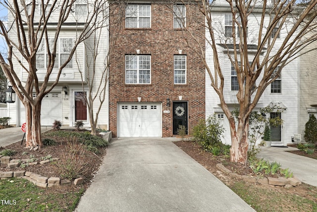 view of front of house with a garage, concrete driveway, and brick siding