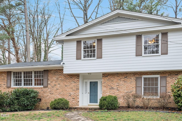 view of front facade featuring crawl space and brick siding