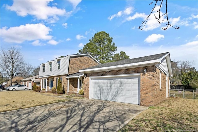 view of front of property featuring a garage, fence, concrete driveway, and brick siding