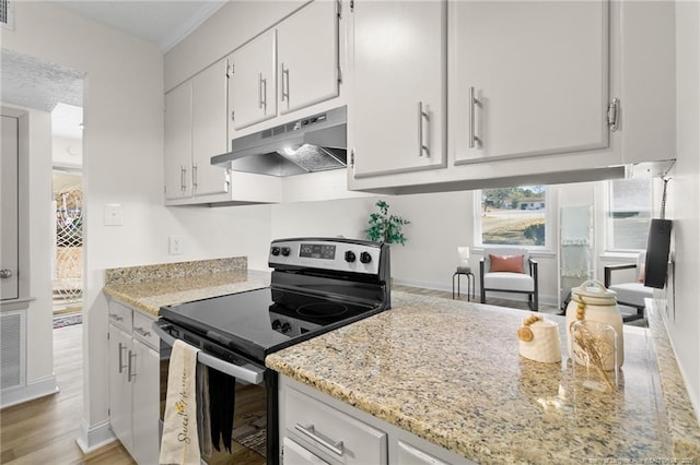 kitchen featuring electric stove, light wood-style flooring, white cabinets, light stone countertops, and under cabinet range hood