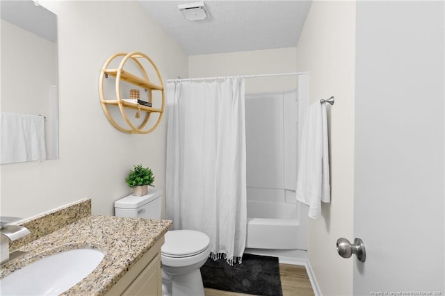 full bathroom with shower / bathtub combination with curtain, toilet, vanity, a textured ceiling, and wood finished floors