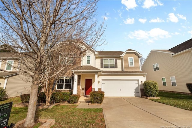 view of front of house featuring a front yard, driveway, and an attached garage