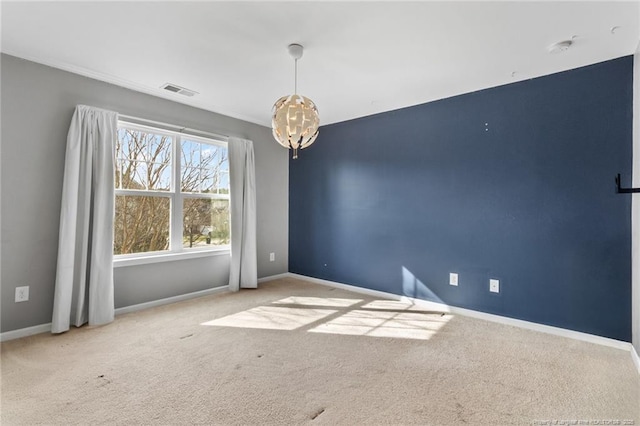 carpeted empty room featuring baseboards, visible vents, and a chandelier