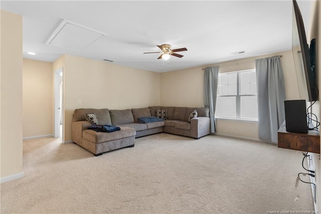 living area with baseboards, a ceiling fan, visible vents, and light colored carpet